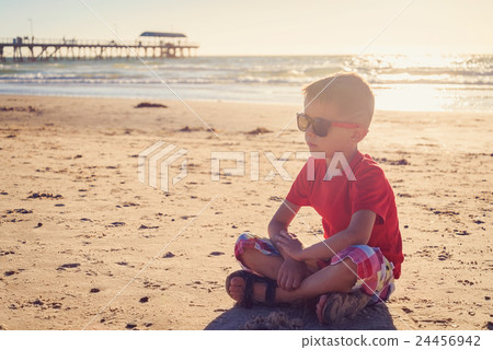 Boy sitting on the beach Boy sitting on the beach 24456942