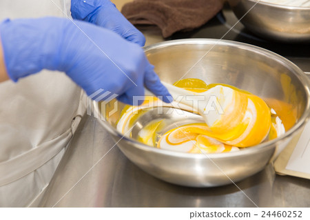 The hand of the pastry making mousse 24460252