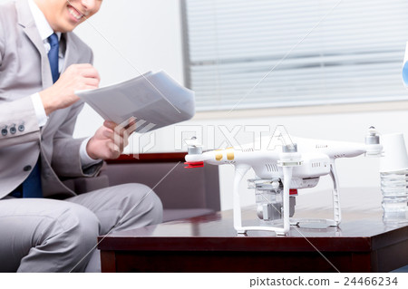 Male employee female employee drone introduction review company unmanned aerial vehicle radio control pilot aircraft quad copter 24466234