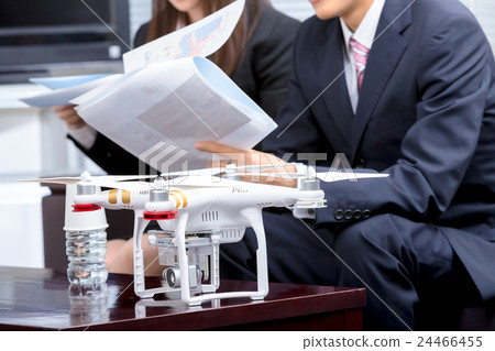 Male employee female employee drone introduction review company unmanned aerial vehicle radio control pilot aircraft quad copter 24466455