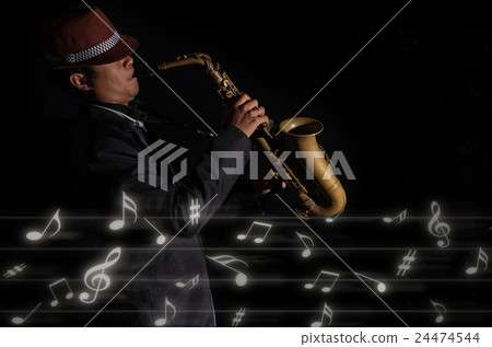 A saxophone player in a dark background with music melody, musical concept A saxophone player in a dark background with music melody, musical concept 24474544