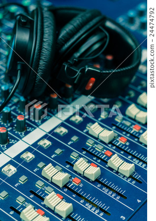 Closeup mixer with Earphone background, music instrument concept Closeup mixer with Earphone background, music instrument concept 24474792