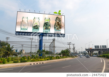 Billboard showing the mix coins and seed in clear bottle on on cityscape photo blurred cityscape background for advertisement, Business investment growth concept Billboard showing the mix coins and seed in clear bottle on on cityscape photo blurred cityscape background for advertisement, Business investment growth concept 24475422