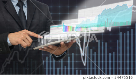 Businessman using the taplet shown the trading graph of stock market on the virtual screen over the stock chart background, Business stock market concept Businessman using the taplet shown the trading graph of stock market on the virtual screen over the stock chart background, Business stock market concept 24475516