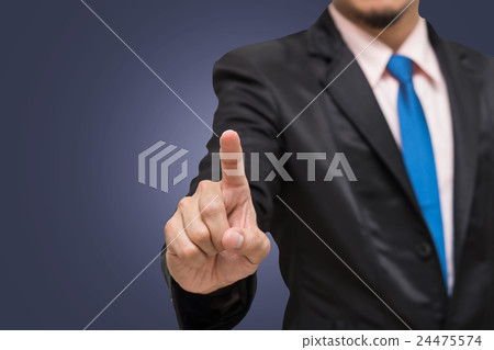 Businessman pointing or touching on dark blue background, include clipping path 24475574