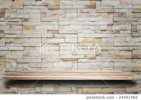 Empty top wooden shelves and stone wall background 24491468
