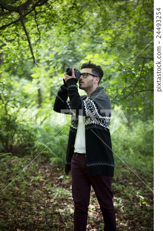Photographer shooting outside with a digital camera. Photographer shooting outside with a digital camera. 24493254