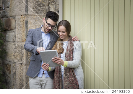 Happy couple using a Digital Tablet. 24493300
