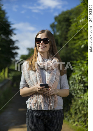 Happy woman using her smart phone outdoors. Happy woman using her smart phone outdoors. 24493302