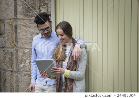 Happy couple using a Digital Tablet. 24493304