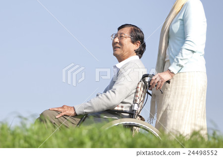 Senior men riding a wheelchair 24498552