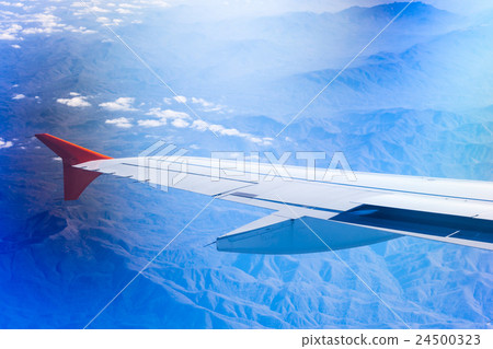 Wing of airplane flying above Caucasus mountains 24500323