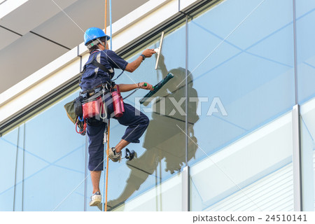 Wiping the window of the building Wiping the window of the building 24510141