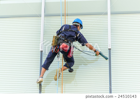 Wiping the window of the building 24510143
