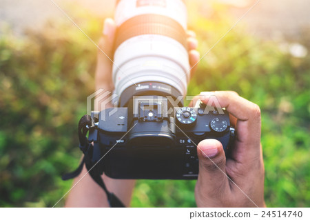 Hand holding camera close up Hand holding camera close up 24514740