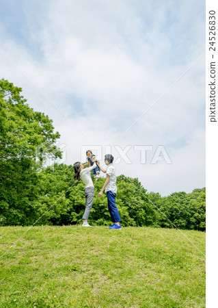 Parents playing in the park of fresh green 24526830