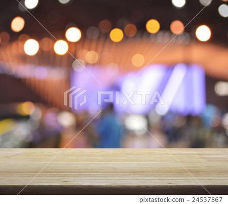 Wooden table over blur light and shadow o fmall Wooden table over blur light and shadow o fmall 24537867