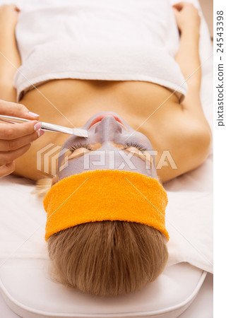 Woman applying mask Woman applying mask 24543398