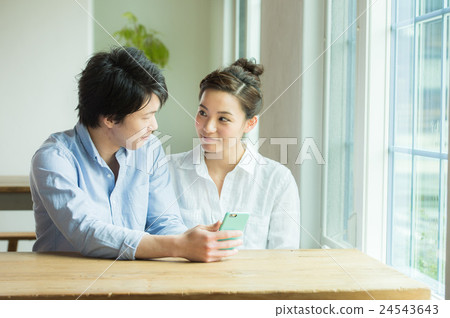 A couple looking at a smartphone 24543643