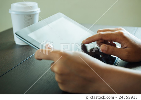 close up hand use tablet on table 24555913