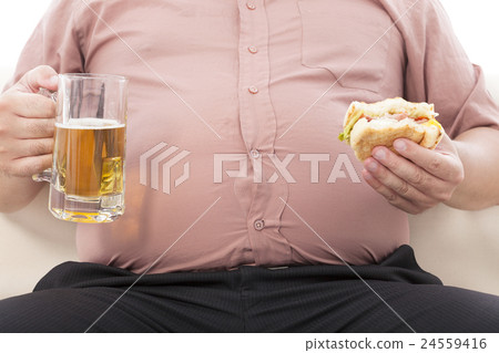 fat business man holding beer mug and hamburger 24559416