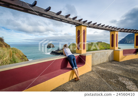 Woman looking at the ocean from special viewpoint Woman looking at the ocean from special viewpoint 24560410