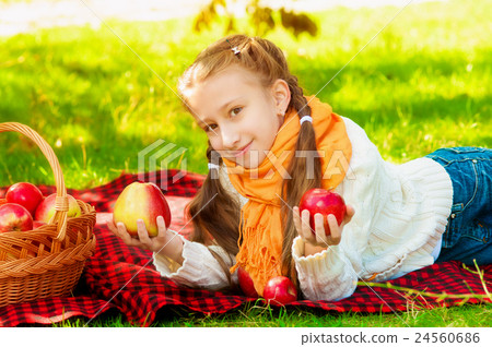 Schoolgirl with apples in autumn park Schoolgirl with apples in autumn park 24560686