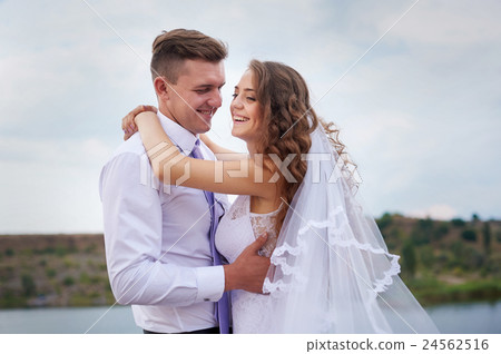 beautiful young couple walking near the lake on beautiful young couple walking near the lake on 24562516