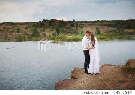 beautiful young couple walking near the lake on 24562517