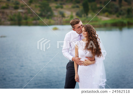 beautiful young couple walking near the lake on beautiful young couple walking near the lake on 24562518