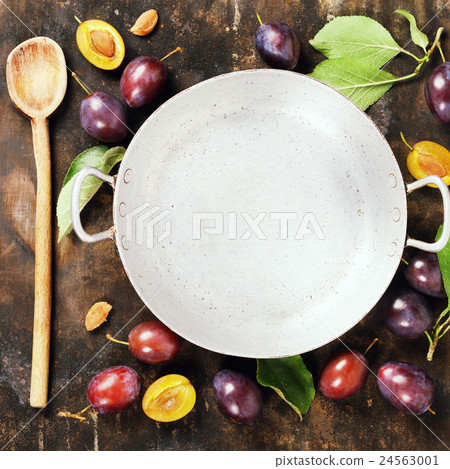 Plums in a bowl on a rural background Plums in a bowl on a rural background 24563001