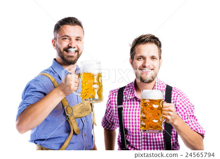 Men in traditional bavarian clothes holding mugs Men in traditional bavarian clothes holding mugs 24565794