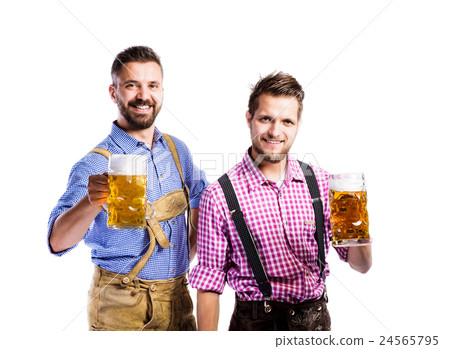 Men in traditional bavarian clothes holding mugs Men in traditional bavarian clothes holding mugs 24565795