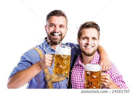 Men in traditional bavarian clothes holding mugs 24565797
