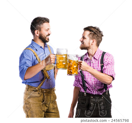 Men in traditional bavarian clothes holding mugs Men in traditional bavarian clothes holding mugs 24565798