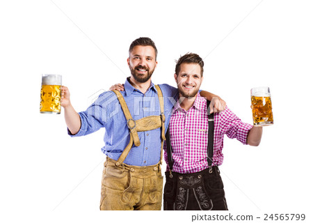 Men in traditional bavarian clothes holding mugs Men in traditional bavarian clothes holding mugs 24565799