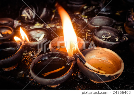 Burning oil lamps at temple 24566403