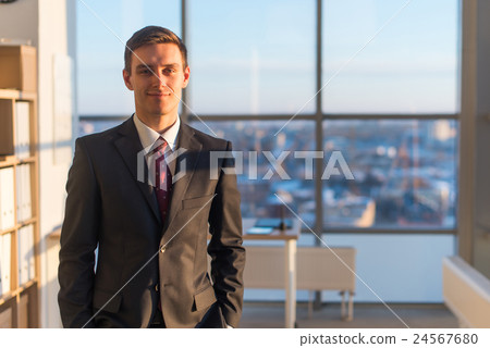 Portrait of businessman, looking at camera 24567680