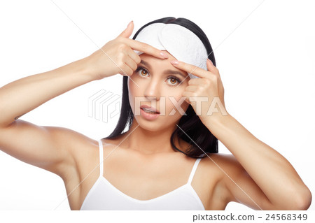 Young woman squeezing her pimple Young woman squeezing her pimple 24568349