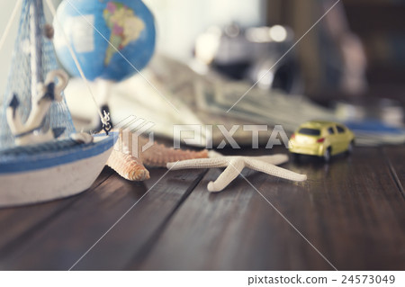map, globe, ship and car figurine, starfish 24573049
