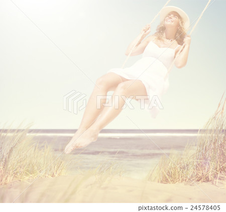 Beautiful Cheerful Woman Swinging by the Beach Beautiful Cheerful Woman Swinging by the Beach 24578405