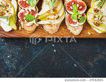 Crostini with pear, ricotta cheese, figs, nuts and 24582681