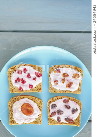 Bread with strawberry cream cheese and dry fruits. 24584942