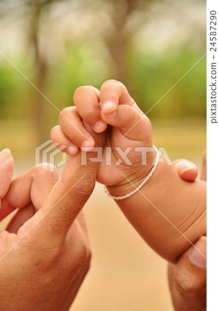 Mother with her newborn baby care hands 24587290