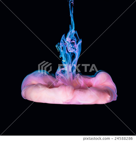 Colored inks in water on black background 24588286