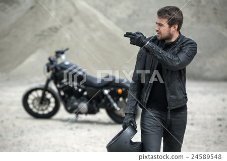 Bearded motorcyclist outdoors 24589548