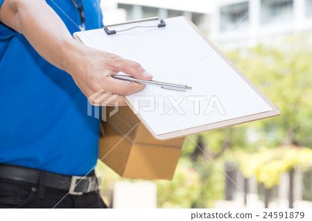Delivery Man holding parcel and giving pen Delivery Man holding parcel and giving pen 24591879
