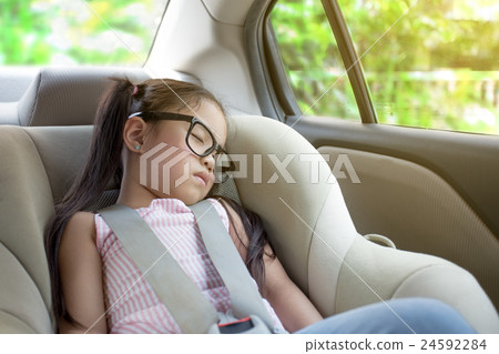 little girl sleeping in the cars eat 24592284