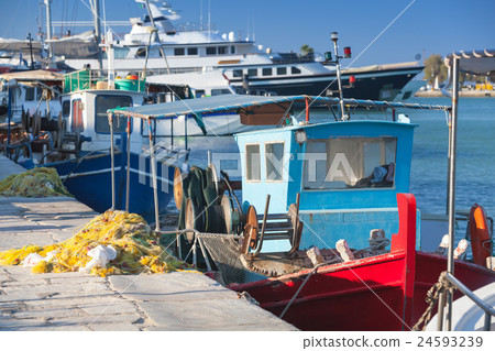 Colorful wooden fishing boats moored in port 24593239