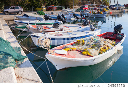 White fishing boats with nets moored in port White fishing boats with nets moored in port 24593250